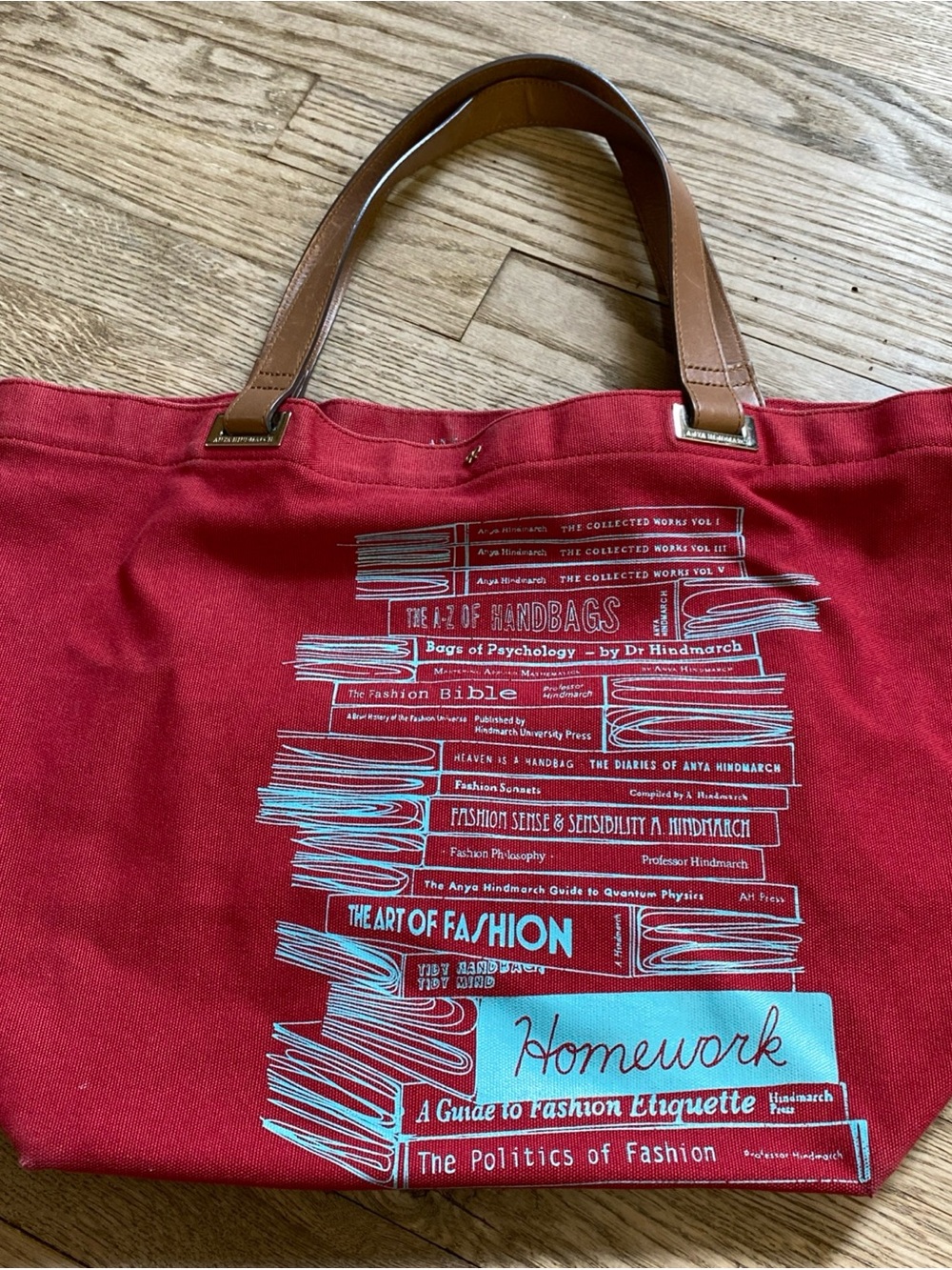 Anya Hindmarch Red Canvas Tote with Brown Leather Handles Stacked Books
